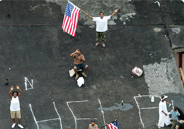 Families stranded on rooftops, waving for rescue helicopters